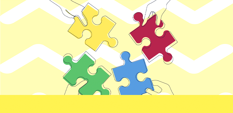 vier Hände, die jeweils ein Puzzlestück halten